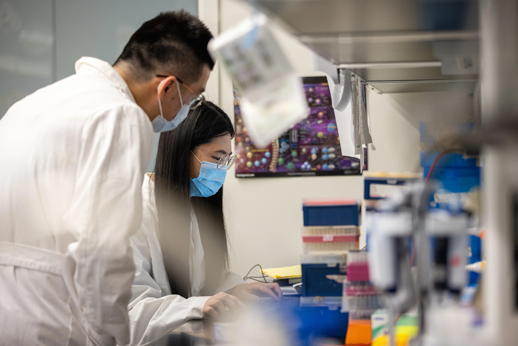 Instructor and student collaborating on project in a lab